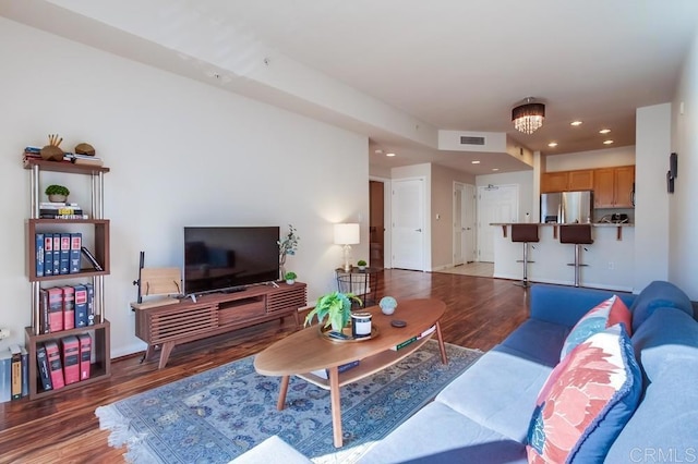 living room featuring dark hardwood / wood-style floors and a notable chandelier