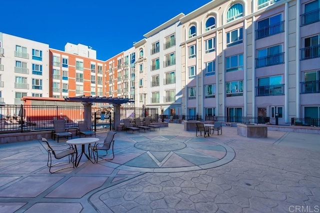 view of community featuring a pergola and a patio