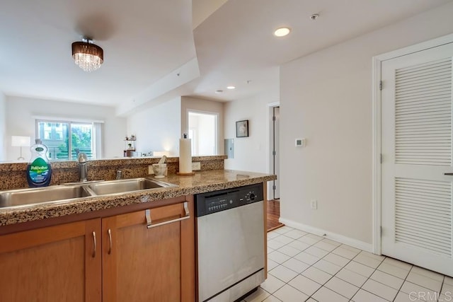 kitchen featuring sink, light tile patterned floors, and dishwasher