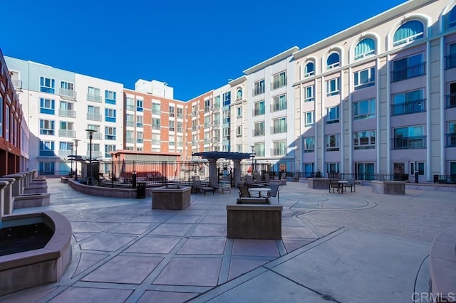 view of home's community with a pergola and a patio