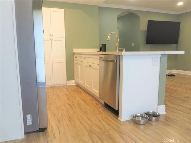 kitchen with white cabinets, light hardwood / wood-style floors, sink, stainless steel dishwasher, and crown molding