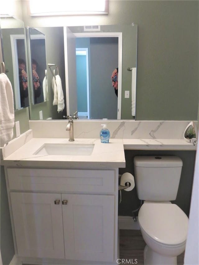 bathroom with toilet and vanity