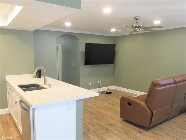 kitchen with white cabinets, dishwasher, sink, light wood-type flooring, and ceiling fan