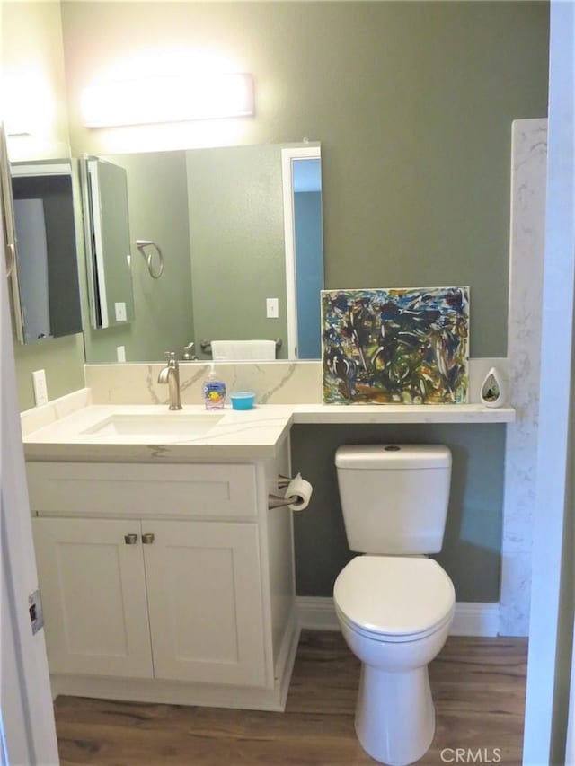 bathroom featuring hardwood / wood-style floors, toilet, and vanity