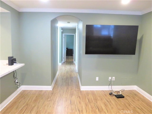 hall with crown molding and light hardwood / wood-style floors