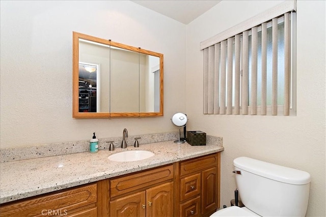 bathroom featuring toilet and vanity