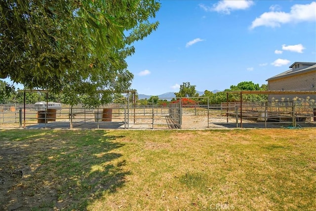 view of yard with a rural view and an outdoor structure