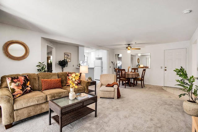 living room with ceiling fan and light colored carpet