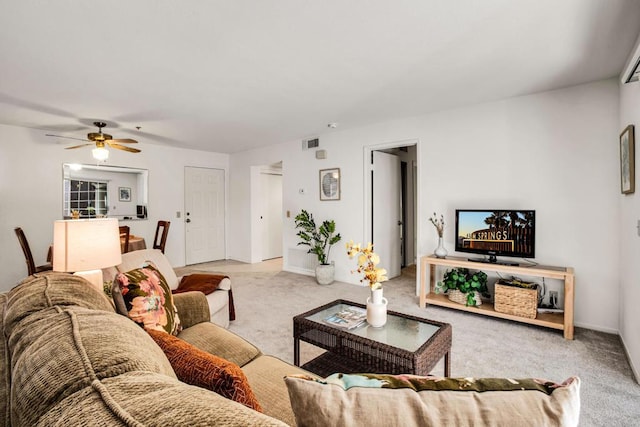 living room with ceiling fan and light colored carpet