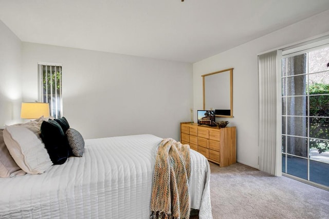 carpeted bedroom featuring access to outside and multiple windows