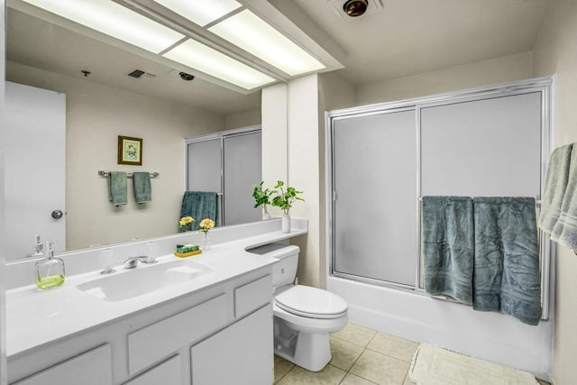 full bathroom with toilet, tile patterned flooring, enclosed tub / shower combo, and vanity