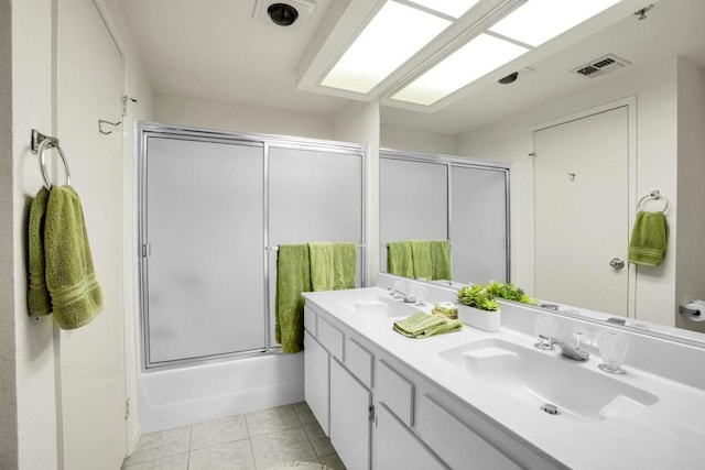 bathroom with bath / shower combo with glass door, tile patterned floors, and vanity