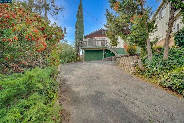 exterior space with a garage and a deck