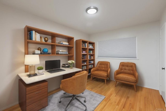 home office with light hardwood / wood-style floors