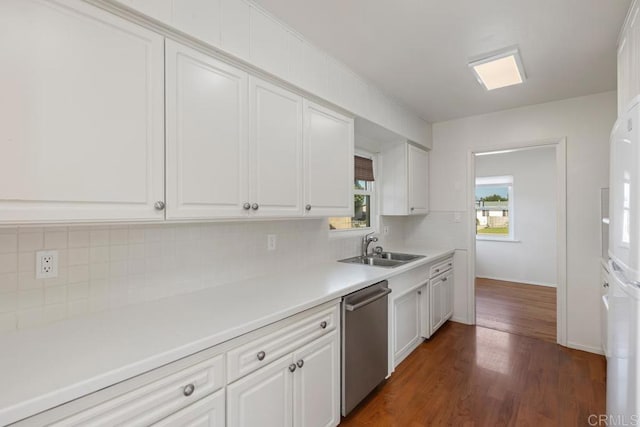 kitchen featuring white cabinetry, dark hardwood / wood-style flooring, tasteful backsplash, sink, and stainless steel dishwasher