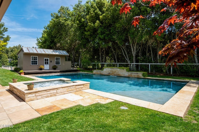 view of pool featuring a patio area, an outbuilding, an in ground hot tub, and a yard