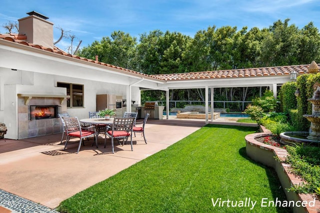 view of patio / terrace featuring a tile fireplace and area for grilling