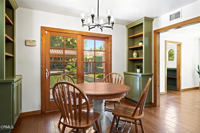 dining room with wood-type flooring and a notable chandelier