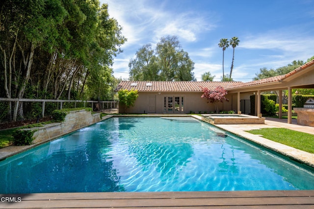 view of swimming pool with an in ground hot tub and a patio area