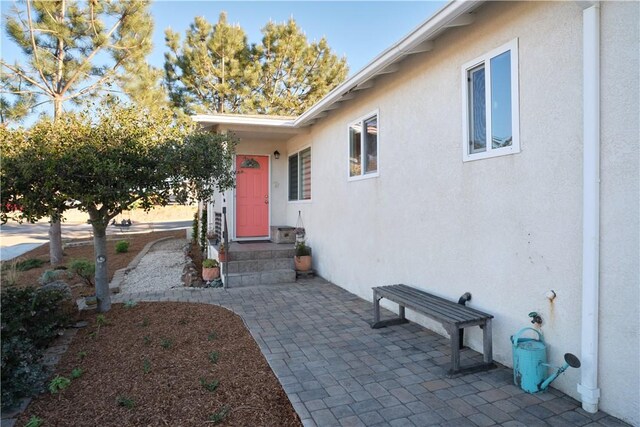 entrance to property featuring a patio