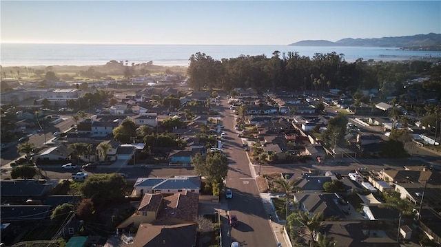 birds eye view of property with a water and mountain view