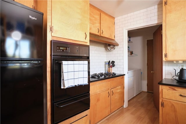 kitchen with black appliances, washing machine and dryer, decorative backsplash, light hardwood / wood-style flooring, and light brown cabinetry