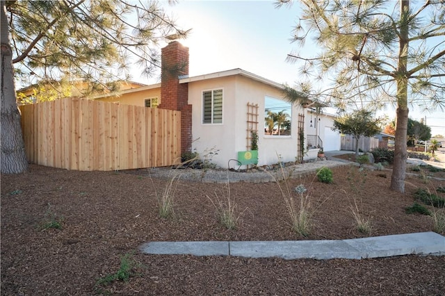 view of side of home featuring a garage