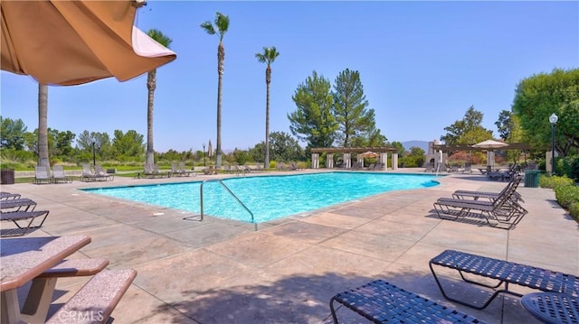 view of pool with a patio and a pergola