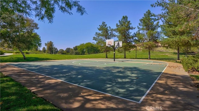 view of sport court with a yard