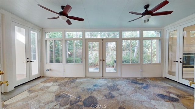 unfurnished sunroom featuring ceiling fan and french doors