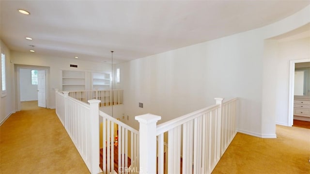 hall featuring light colored carpet