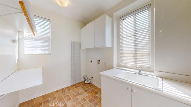 clothes washing area with cabinets, electric dryer hookup, sink, and washer hookup