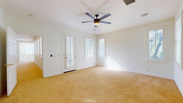 carpeted empty room featuring ceiling fan