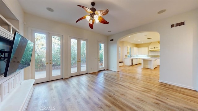 interior space with french doors, ceiling fan, light hardwood / wood-style flooring, and a wealth of natural light