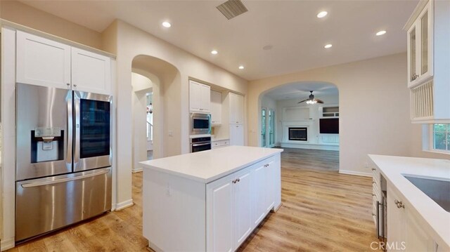 kitchen featuring a kitchen island, white cabinetry, and appliances with stainless steel finishes