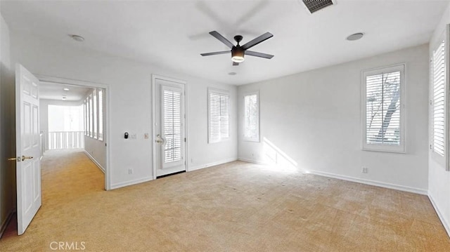 empty room featuring light carpet and ceiling fan