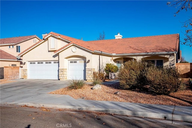 mediterranean / spanish-style home featuring a garage