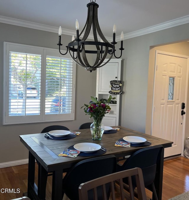 dining space featuring ornamental molding, a chandelier, and wood-type flooring