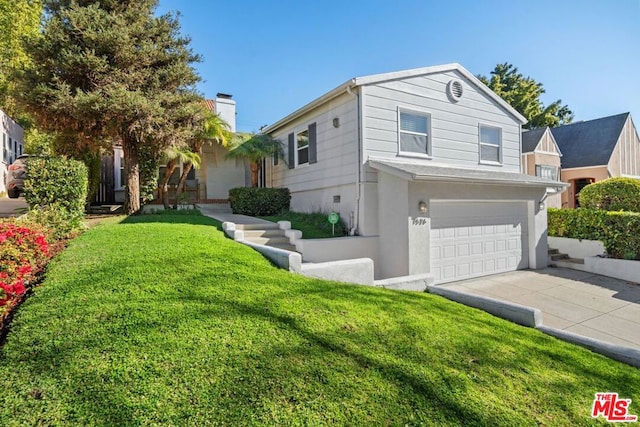 view of front of home with a front lawn and a garage