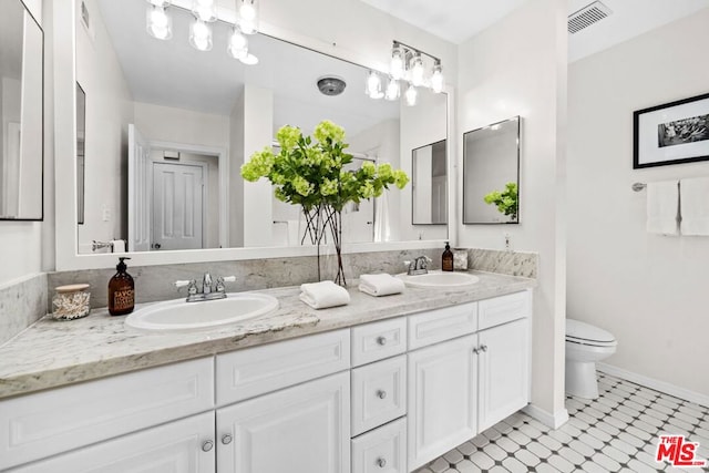 bathroom with toilet and vanity