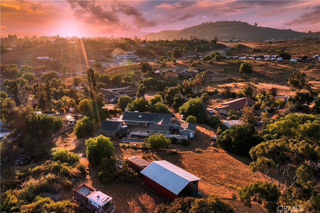 aerial view at dusk featuring a mountain view