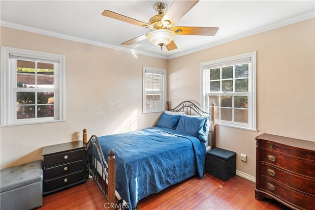 bedroom with multiple windows and wood-type flooring