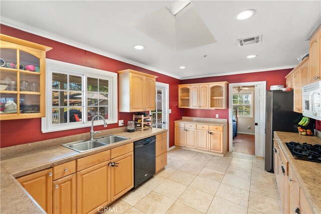 kitchen featuring sink, crown molding, light tile patterned floors, black appliances, and light brown cabinets