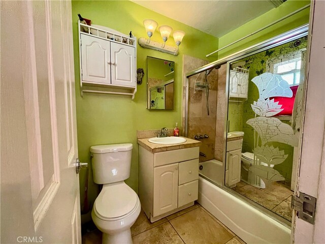 full bathroom with enclosed tub / shower combo, tile patterned floors, toilet, and vanity