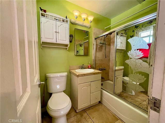 full bathroom featuring tile patterned flooring, bath / shower combo with glass door, vanity, and toilet