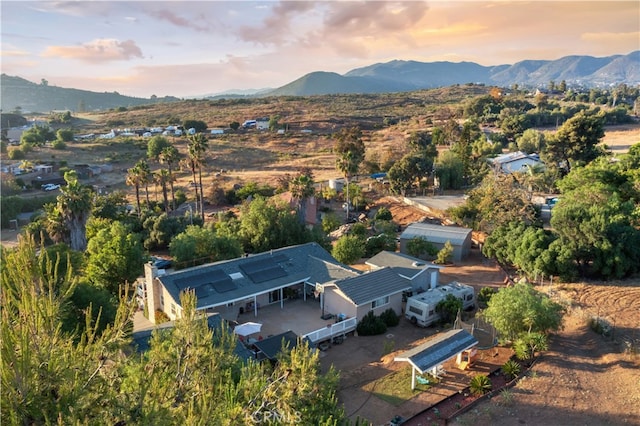 aerial view at dusk featuring a mountain view