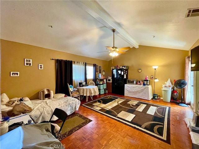 bedroom featuring ceiling fan, lofted ceiling with beams, a textured ceiling, black fridge, and parquet flooring