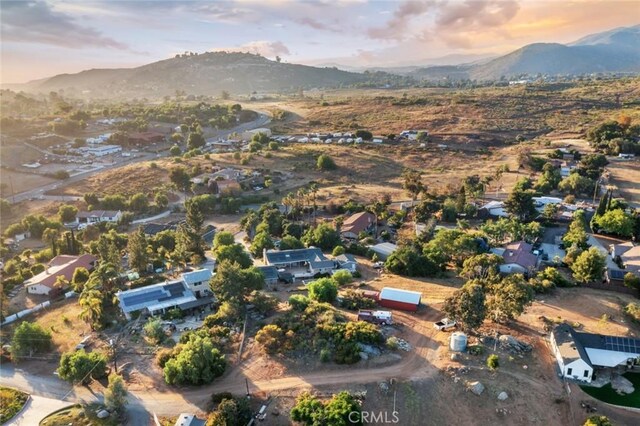 aerial view at dusk featuring a mountain view