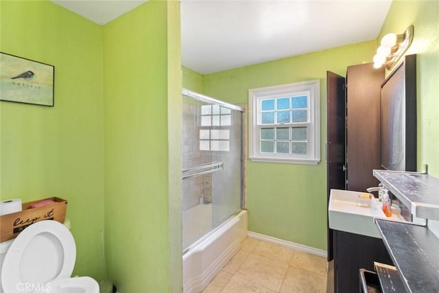 full bathroom featuring tile patterned flooring, enclosed tub / shower combo, vanity, and toilet