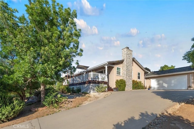 view of property exterior featuring a wooden deck and a garage